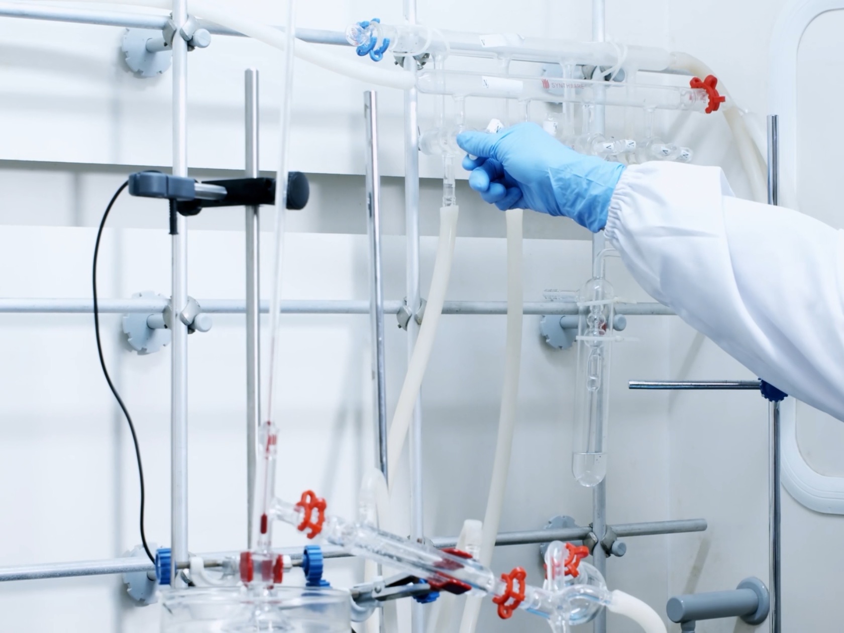 A professional glass Schlenk line setup in a chemistry laboratory, featuring a dual-manifold vacuum and inert gas system used for air-sensitive reactions.