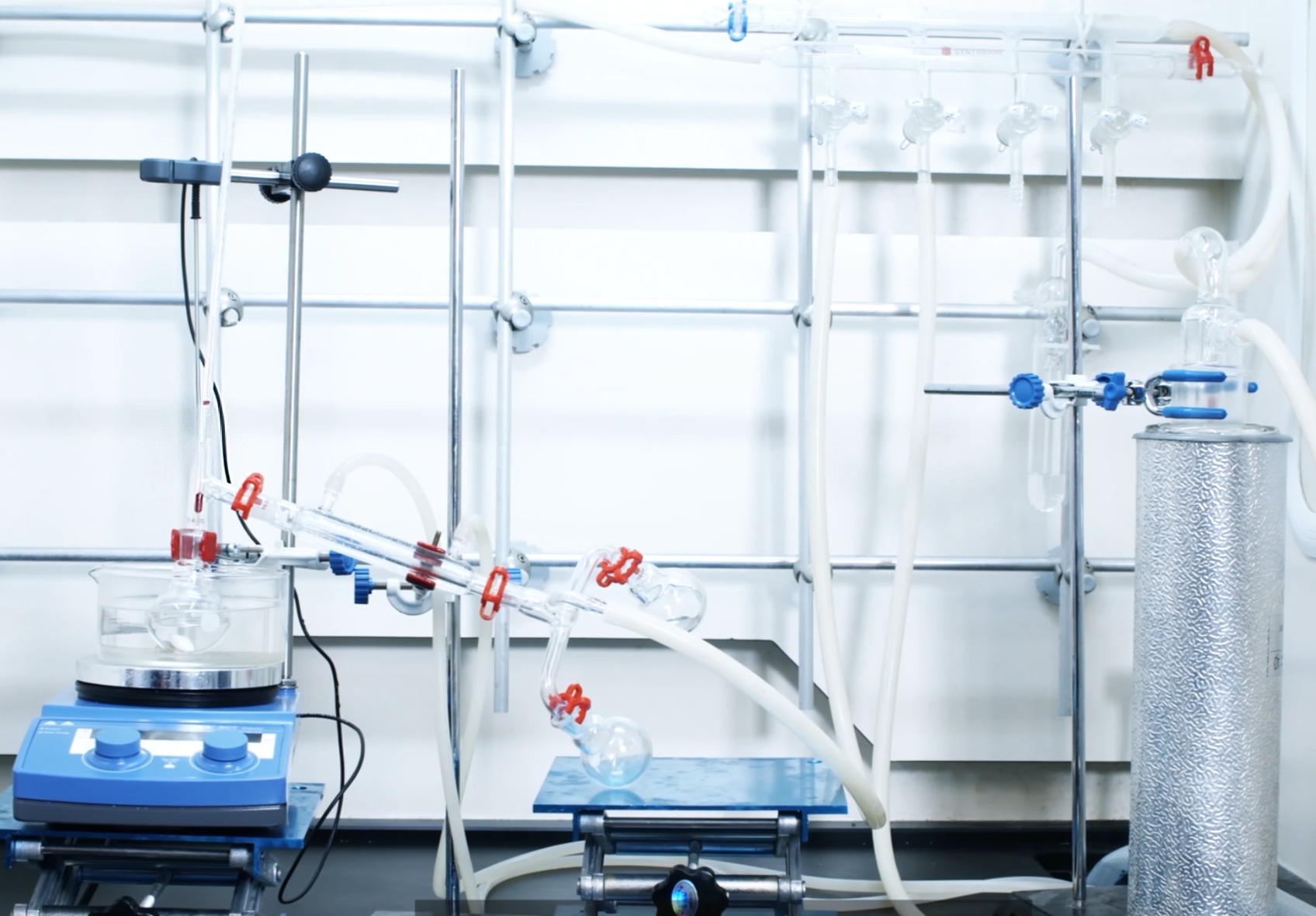 Complete organic lab setup overview showing ground-glass joints, clamps, support hardware, tubing connections, and key sealing and flow-path components in one assembled system.