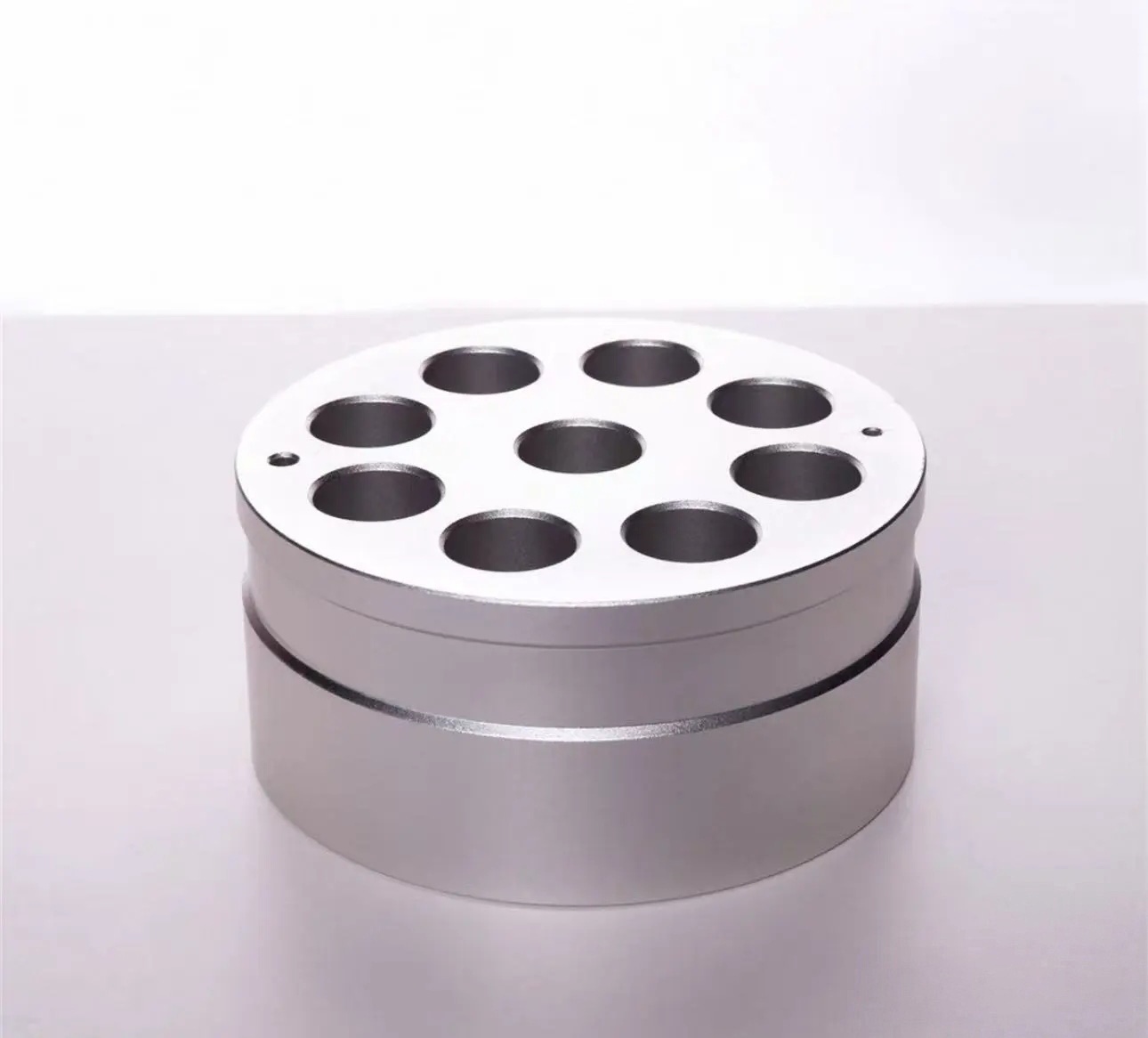 Metal heating block used for small reaction vessels in organic lab work