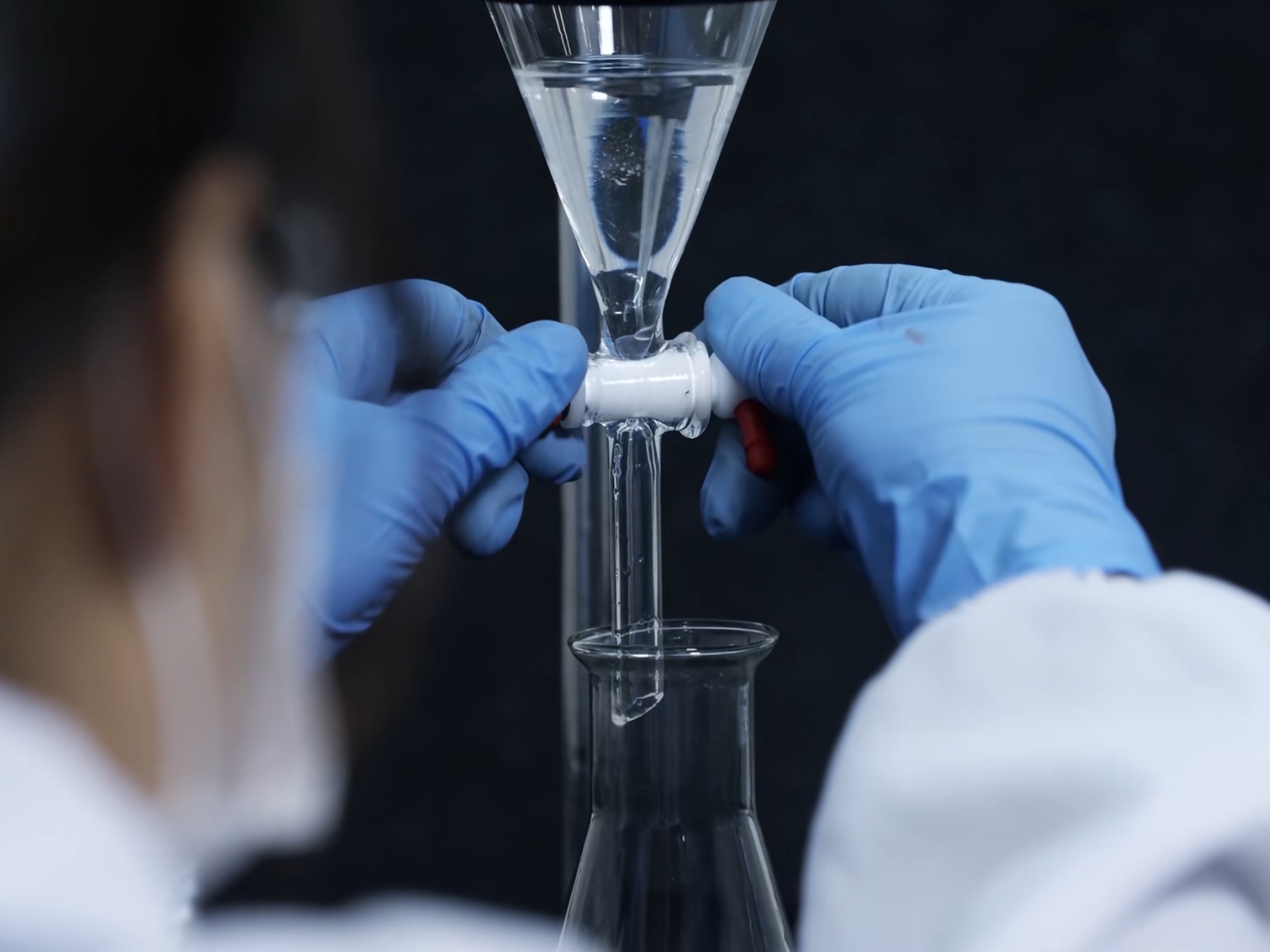 A separatory funnel workflow showing controlled phase separation and collection during liquid-liquid extraction